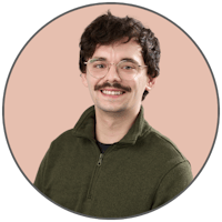 a young man wearing glasses and a hawaiian shirt